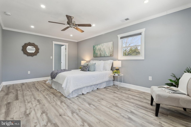 bedroom featuring ceiling fan, light hardwood / wood-style floors, and crown molding