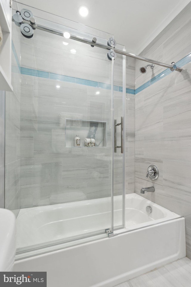 bathroom featuring shower / bath combination with glass door