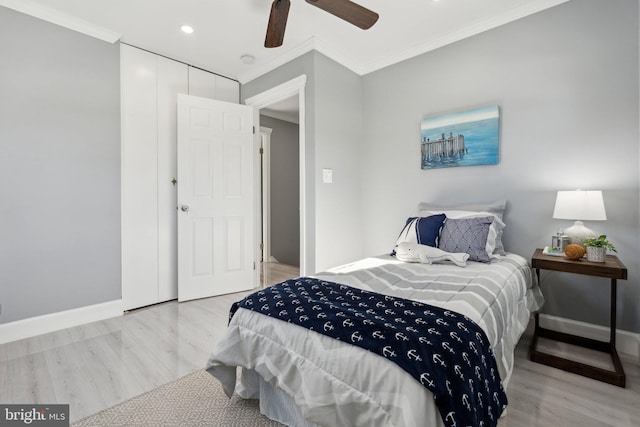 bedroom with ceiling fan, light hardwood / wood-style floors, and ornamental molding