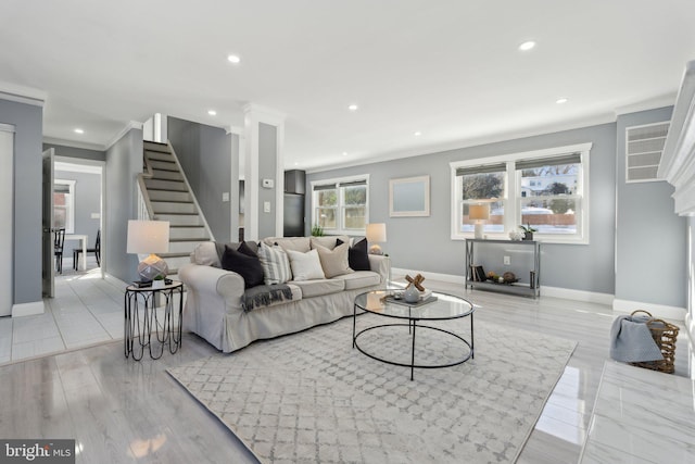 living room featuring plenty of natural light and ornamental molding