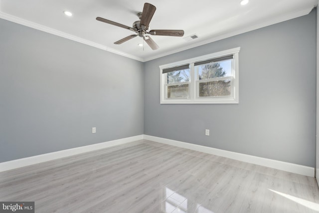 empty room featuring ceiling fan, light hardwood / wood-style floors, and crown molding