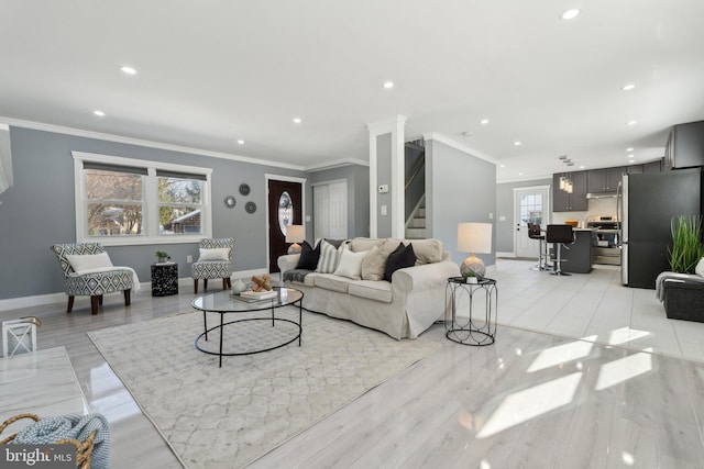 living room with light hardwood / wood-style floors and ornamental molding