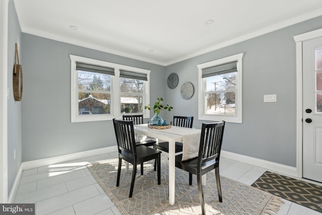 tiled dining space featuring a wealth of natural light and crown molding