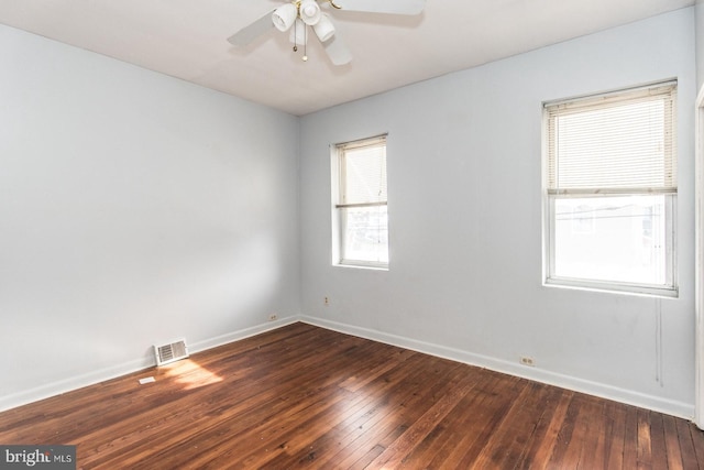 spare room featuring ceiling fan and dark wood-type flooring