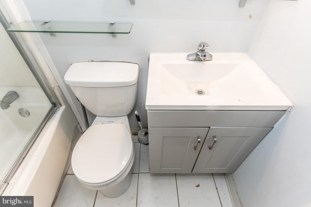 full bathroom with tile patterned flooring, vanity, enclosed tub / shower combo, and toilet