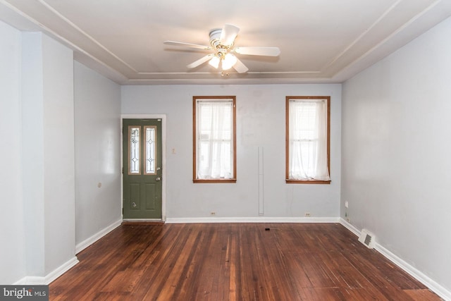 foyer entrance with ceiling fan, dark wood-style flooring, and baseboards