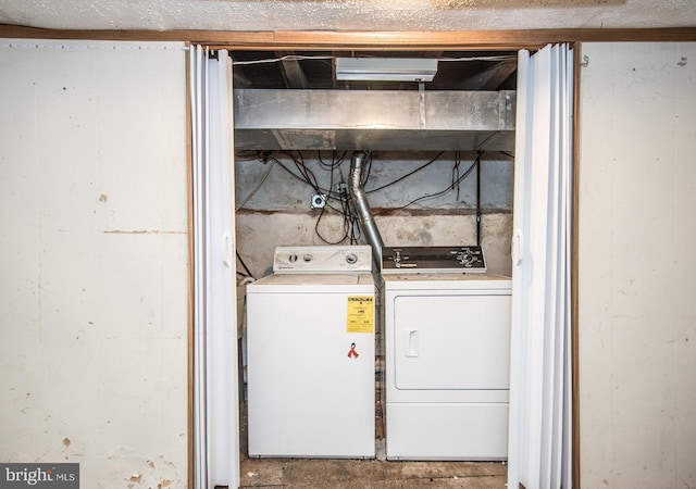 clothes washing area featuring independent washer and dryer