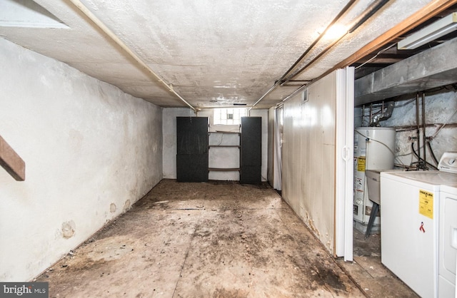 basement with separate washer and dryer and water heater