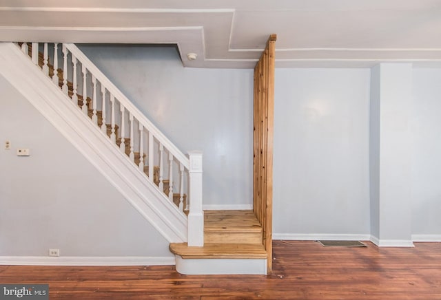 stairs with hardwood / wood-style flooring