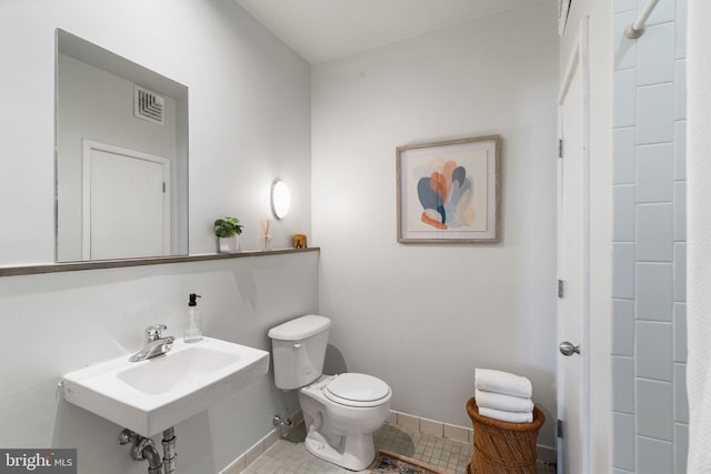 bathroom with tile patterned floors, sink, and toilet