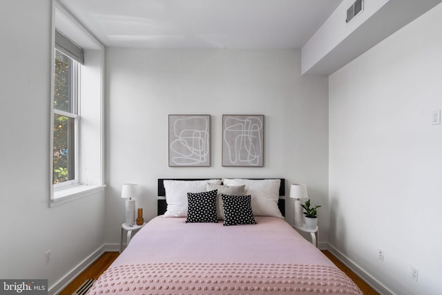 bedroom with wood-type flooring