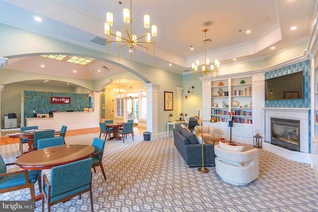 living room with an inviting chandelier, carpet, ornate columns, and a raised ceiling