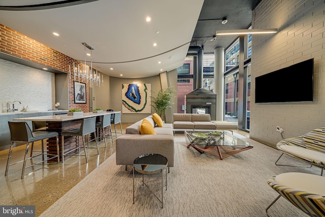 living room featuring sink and brick wall