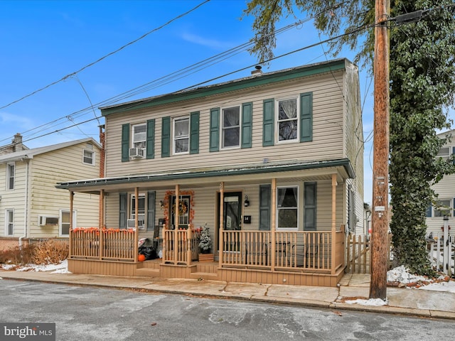 view of front of home featuring cooling unit and covered porch