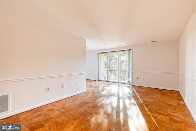 spare room with light parquet floors