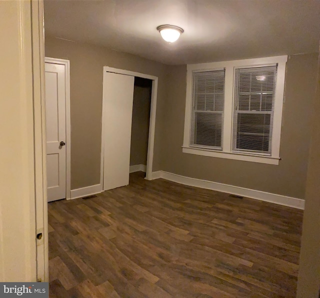 unfurnished room featuring dark hardwood / wood-style floors