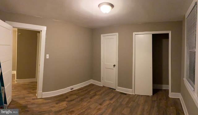 unfurnished bedroom with dark hardwood / wood-style floors