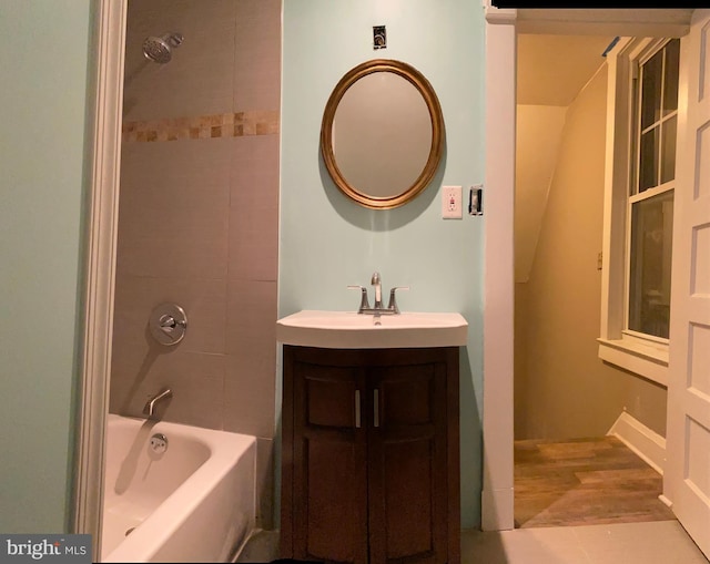 bathroom with vanity and tiled shower / bath combo