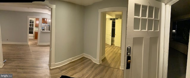 hallway with hardwood / wood-style flooring