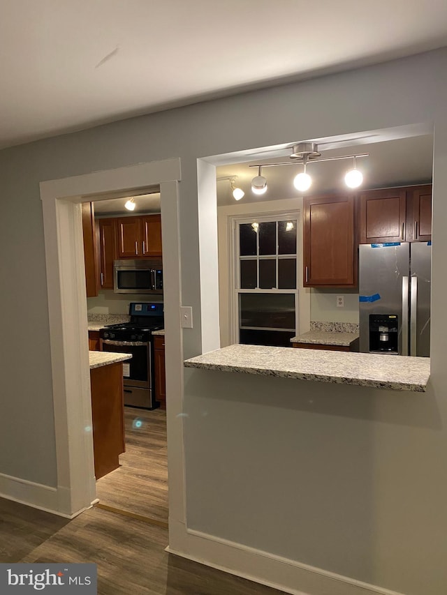 kitchen with dark wood-type flooring and appliances with stainless steel finishes