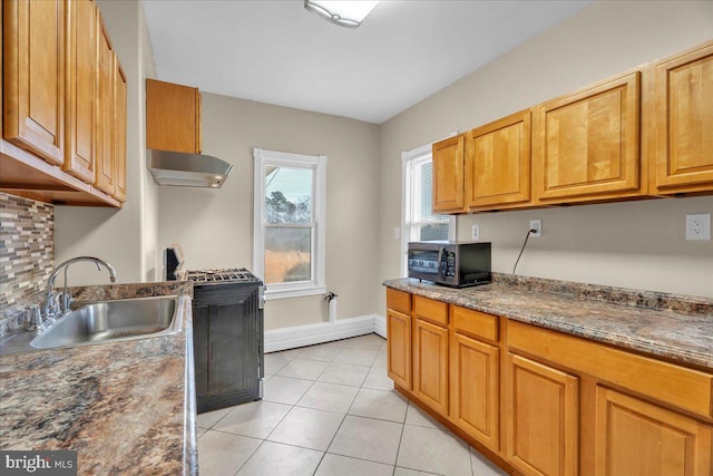 kitchen with stone counters, sink, range hood, backsplash, and light tile patterned floors