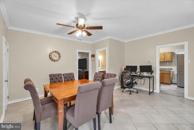 tiled dining space with ceiling fan and ornamental molding