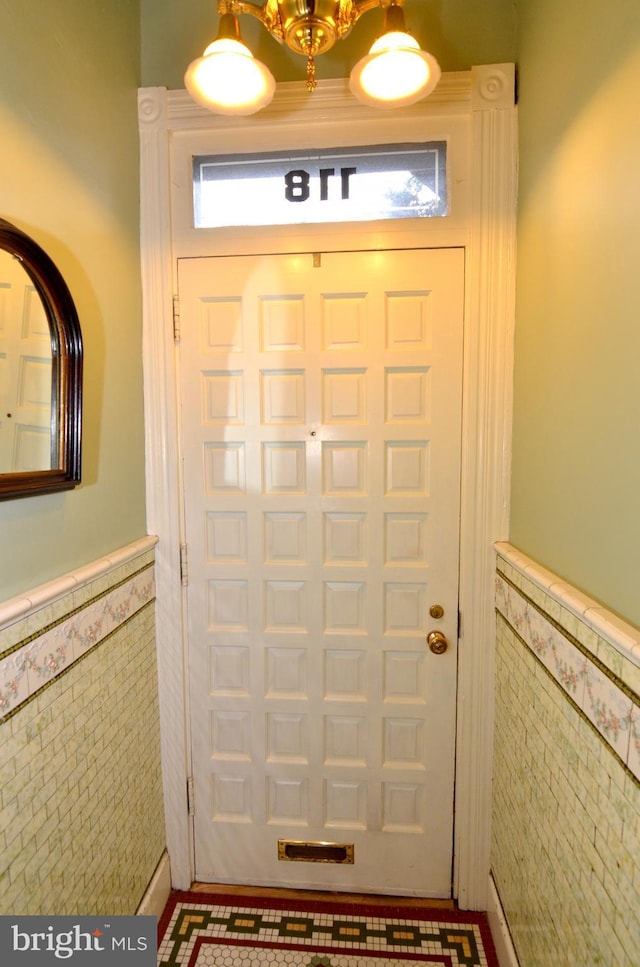 entryway with tile walls and a healthy amount of sunlight