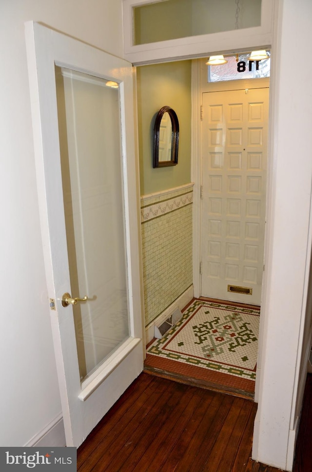 entryway with tile walls and dark hardwood / wood-style floors