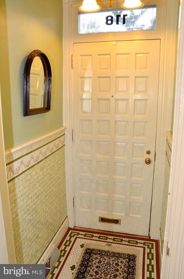 foyer with tile walls