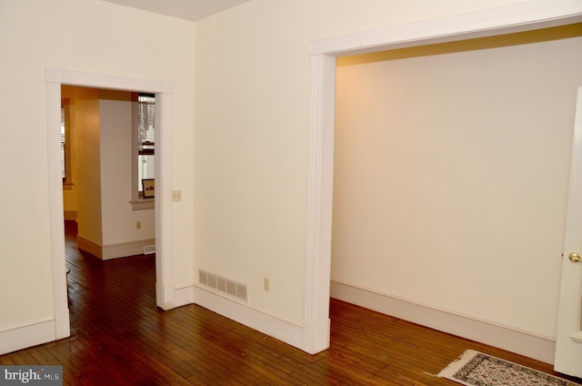 spare room with dark hardwood / wood-style flooring