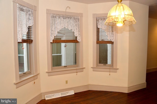 interior space featuring an inviting chandelier and hardwood / wood-style floors