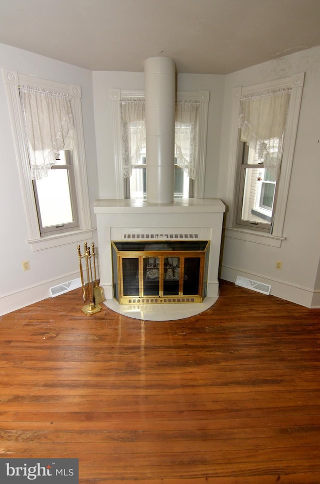 unfurnished living room featuring heating unit