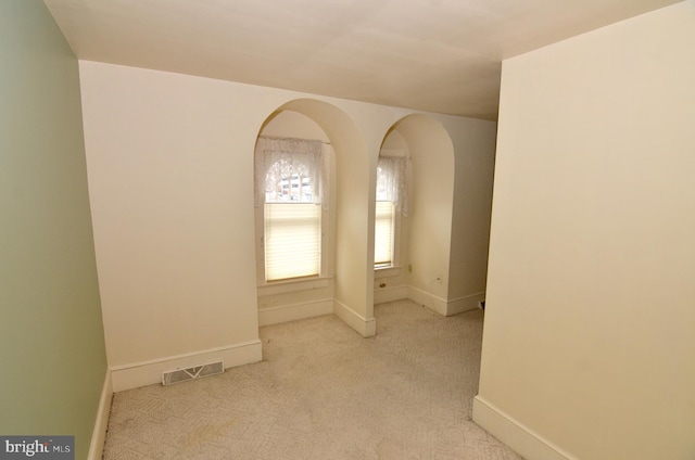 empty room with light colored carpet