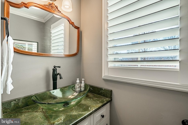 bathroom with plenty of natural light, vanity, and ornamental molding