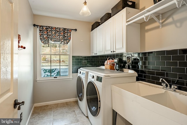 laundry area with cabinets, sink, and washing machine and clothes dryer