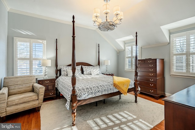 bedroom featuring hardwood / wood-style flooring, ornamental molding, and multiple windows