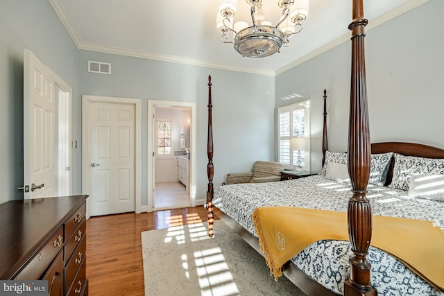 bedroom with light hardwood / wood-style flooring, a notable chandelier, ensuite bathroom, and ornamental molding