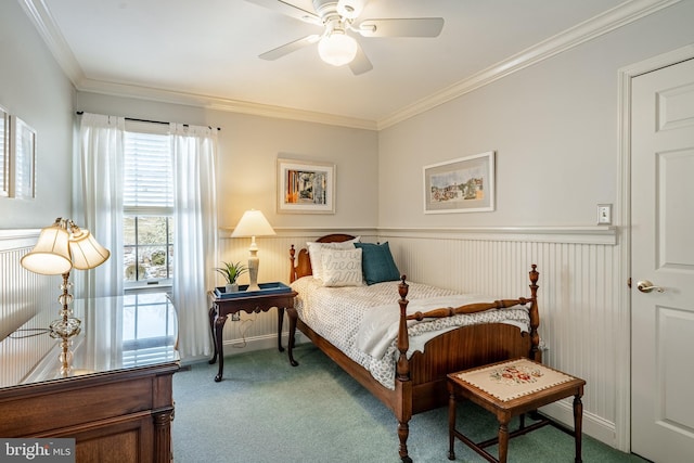 carpeted bedroom featuring crown molding and ceiling fan