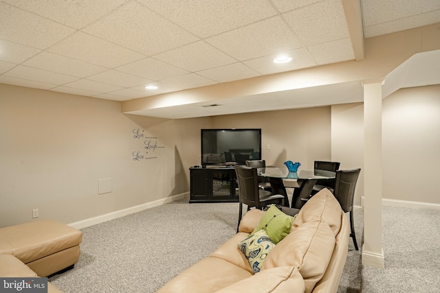 living room with carpet flooring and a paneled ceiling