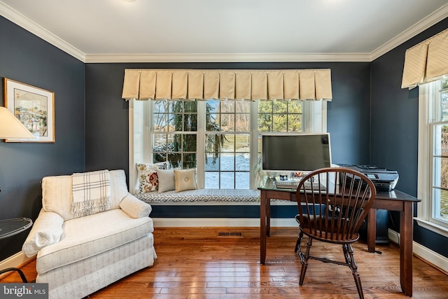 sitting room featuring wood-type flooring and ornamental molding