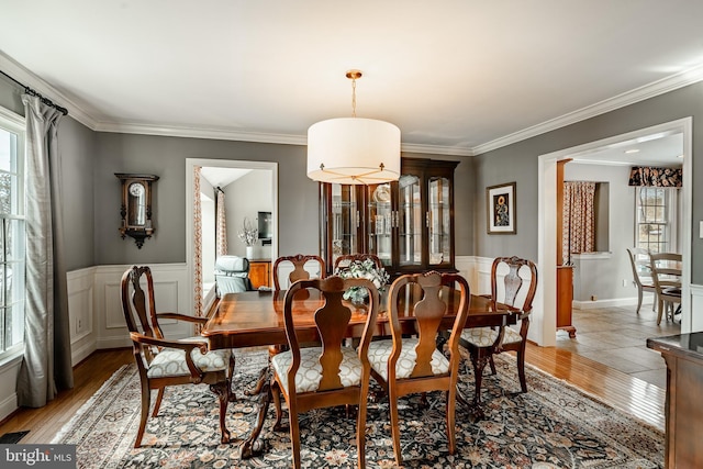 dining room with ornamental molding and hardwood / wood-style floors