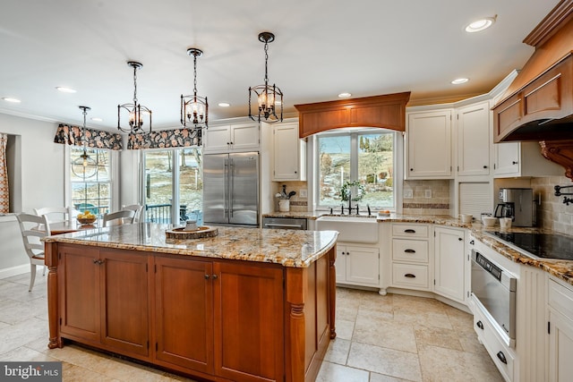 kitchen featuring white cabinetry, sink, pendant lighting, and stainless steel appliances