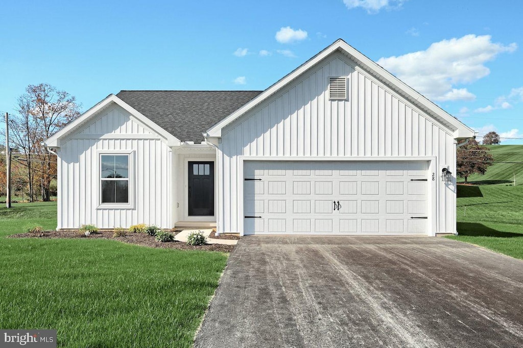 modern inspired farmhouse with a garage and a front yard