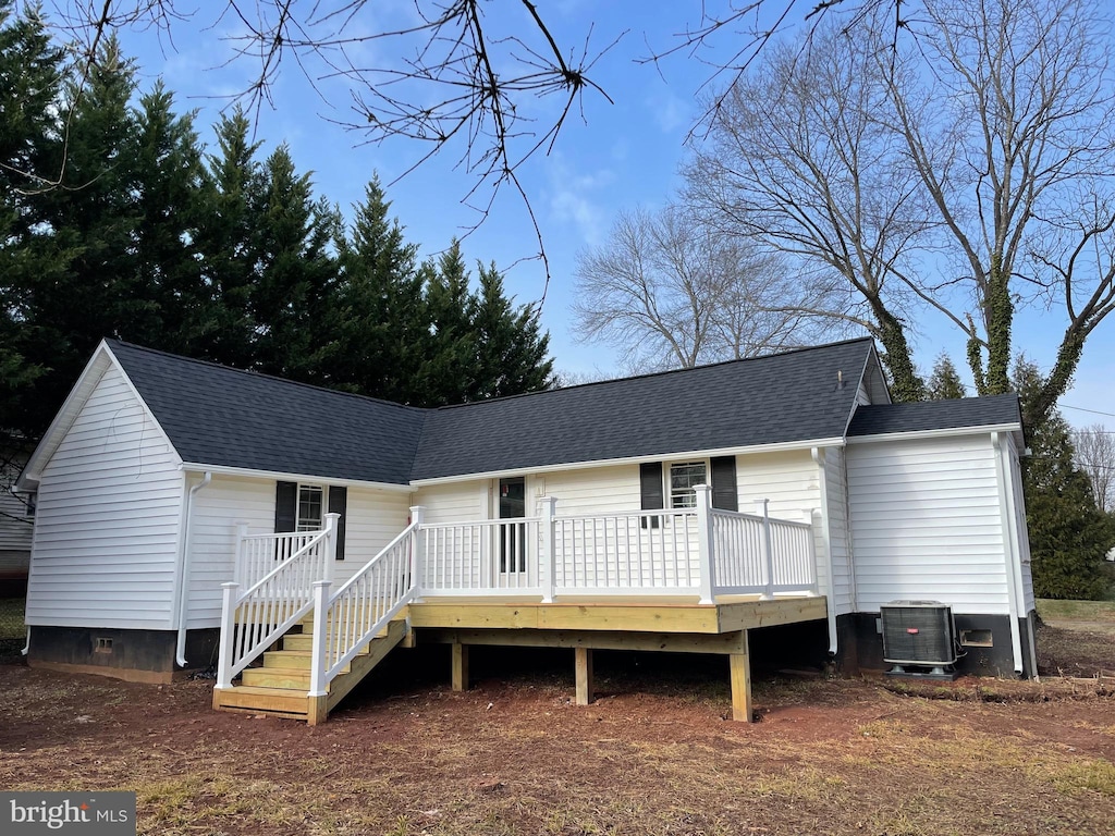 view of front of property with a deck and cooling unit