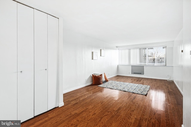 unfurnished living room featuring wood-type flooring