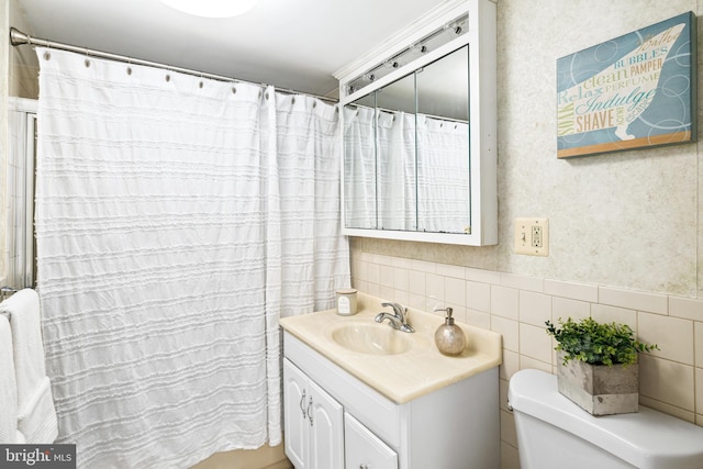 bathroom with a shower with curtain, vanity, tile walls, and toilet