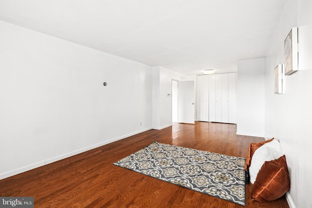 spare room with dark wood-type flooring