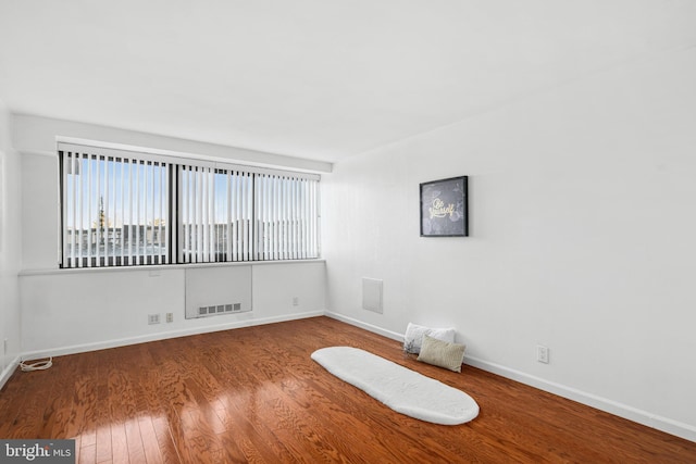 spare room with wood-type flooring