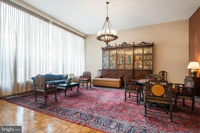 interior space featuring parquet floors and an inviting chandelier