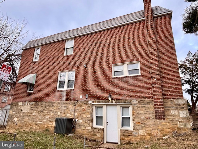 back of house featuring central air condition unit